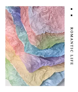 Detail shot of multi-color gradient tissue paper, crumpled texture for floral packaging and bouquet wrapping.