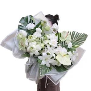 Large white and green fresh floral bouquets with elegant border wrapping paper