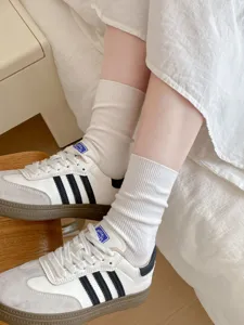 Cotton mid-tube socks for women, soft ribbed knit design, comfortable daily casual wear.