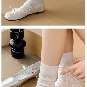 Detailed view of trendy Korean style women flat shoes and breathable crew socks.