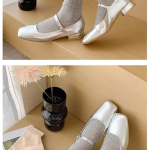 Silver metallic Mary Jane flats paired with stylish grey ribbed socks for daily wear.