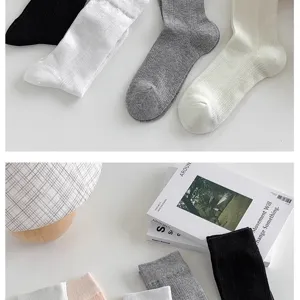 Detail view of minimalist solid color women socks in neutral shades, soft cotton fabric.