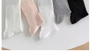 Detailed view of women's summer breathable cotton mid-tube socks in assorted colors.