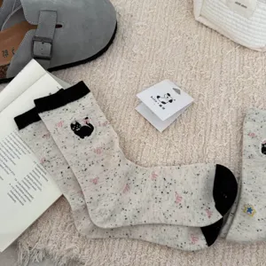 Cute women's mid-tube speckled yarn socks with lovely black cat embroidery and sweet bow details.