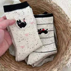 Cute black cat embroidered mid-calf socks detail shot showing cozy cotton knit fabric.