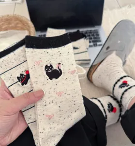 Cute cartoon black cat embroidered mid-tube slouch socks, soft speckled yarn fabric detail.