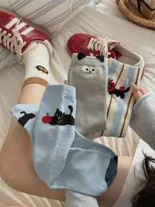 Cute cartoon cat mid-tube socks detail shot, soft cotton material, cozy bedroom scene display.