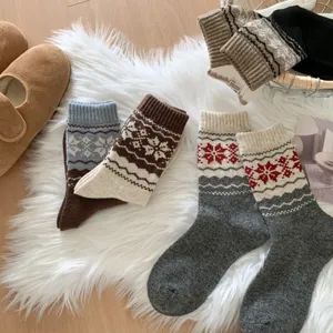 Cozy Fair Isle winter wool socks with vintage color block snowflake patterns for chilly days.