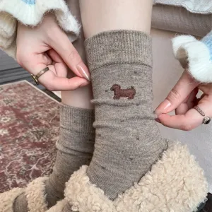 Detail view of cute dachshund embroidered wool cashmere socks with polka dot pattern for women warm.