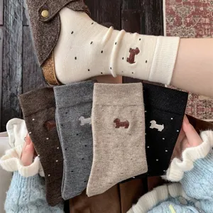 Close-up detail of cozy wool blend winter socks featuring cute dachshund embroidery and cute dots.