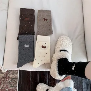 Close-up view of cute dachshund embroidered polka dot mid-tube socks for cozy autumn wear.