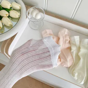Close-up detail of women breathable mesh mid-tube socks in white and pink, soft and stylish.