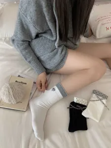 Comfortable cotton mid-calf socks for women featuring cute heart bow and chic color block design.