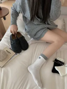 Cozy winter women crew socks with cute heart bow detail and contrast grey cuffs for daily wear.