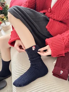 Christmas wool socks detailed view, featuring cute embroidered Santa and cozy folded cuff design.