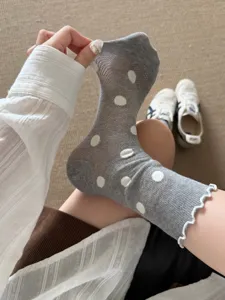 Detailed view of grey sheer mesh crew socks with white polka dots, summer breathable style