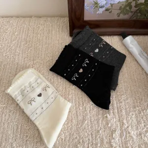 Cozy women knit mid-tube socks featuring cute heart and bow patterns for daily wear.