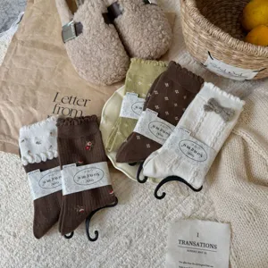 Cashmere texture wool blend slouchy socks with floral embroidery and cute bow detail.