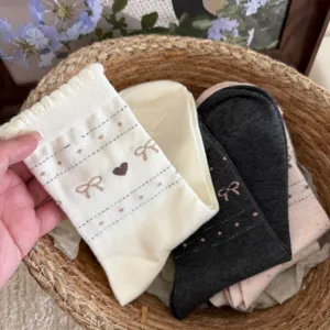 Korean style cute bow heart mid-calf cotton socks for women, soft bubble cuff casual socks detail.