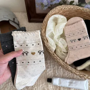 Detailed view of women's Korean style cotton crew socks with cute bows and heart patterns.