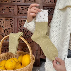 Olive green knit socks with floral lace cuff, comfortable winter thermal hosiery detail shot.