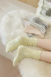 Cozy thickened cashmere blend women crew socks in cream color with colorful speckles yarn design.