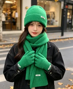 Winter green knit three piece set including beanie hat scarf and warm gloves for women.