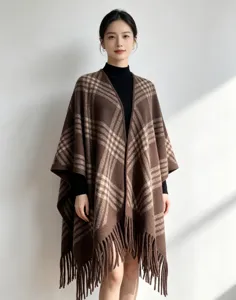 Detail view of the brown plaid tassel cape, featuring soft texture and elegant fringe hem.