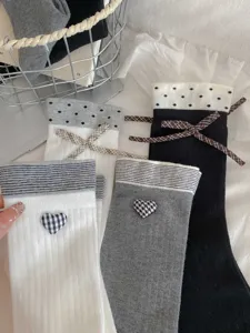 Cute bow heart cotton women socks detail view, cozy winter slouch hosiery fashion style.