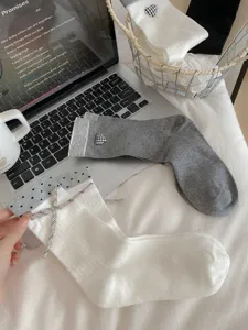 Detailed view of women casual cotton socks with cute heart patterns and sweet bow accents.