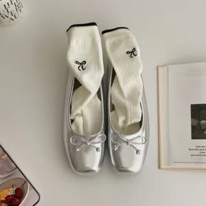 Chic silver square toe ballet flats paired with embroidered bow white socks for modern daily wear.