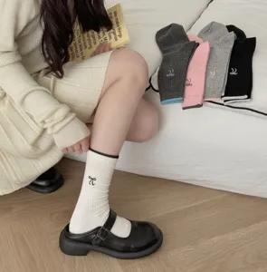 Korean style women's crew socks featuring cute bow embroidery and contrast color details.