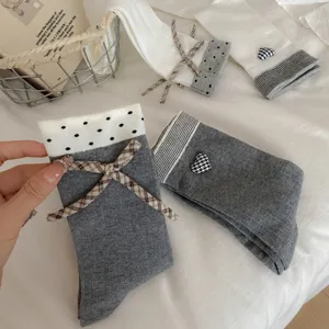 Women cotton mid-tube socks with cute bow and heart design flat lay main product view