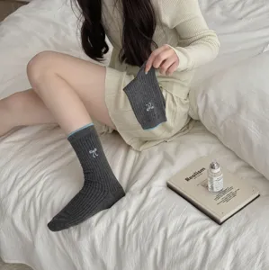 Korean style grey ribbed crew socks with blue contrast trim and embroidered bow detail detail view