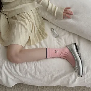 Korean style knitted outfit paired with pink bow embroidered socks and shiny silver shoes.