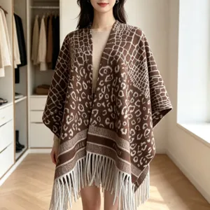 Fashionable brown animal print knitted cape poncho with fringe hem, chic winter wrap for women.