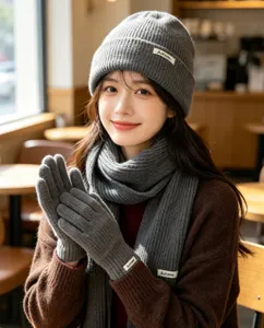 Cozy grey knit winter three-piece set including warm beanie hat scarf and comfortable gloves.