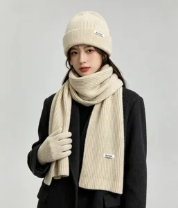 Cozy beige knit beanie hat, scarf, and gloves set detail showcasing soft ribbed wool texture.