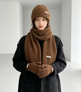 Brown knitted hat scarf and gloves set for women, winter warm three-piece wool accessory outfit.