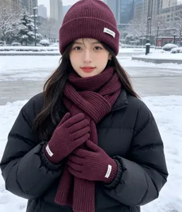 Winter three-piece set featuring a knitted beanie, cozy scarf, and warm gloves in rich maroon.