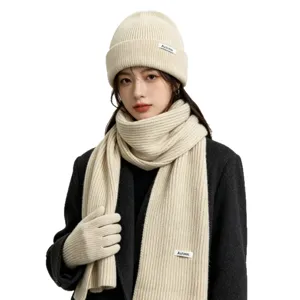 Women winter knit three-piece set including beanie hat scarf and gloves in solid beige color.