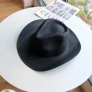 Clásico sombrero de sol de paja negro con ala ancha para playa y vacaciones de verano.