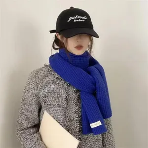 Close up detail view of the Klein blue knitted scarf, cozy winter neck warmer for women and men.