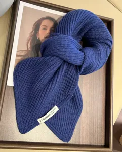 Dark blue chunky knit short scarf, cozy winter neck warmer with stylish brand label detail.
