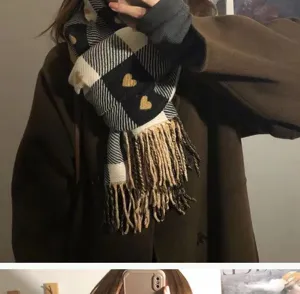 Detailed view of the milk coffee plaid scarf featuring cute embroidered hearts and soft fringe.