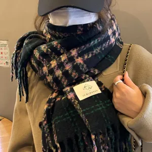 Detailed view of women's retro plaid fringe winter scarf, showcasing soft texture and cozy wear.
