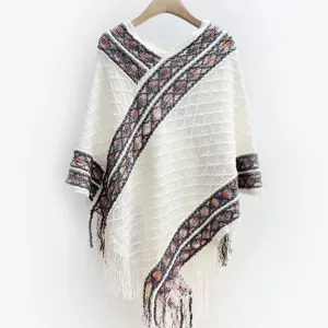 Comfortable white knit poncho with tribal stripe pattern and fringe hem for outdoor travel.