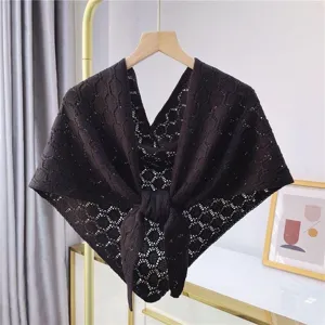 Black hollow-out knit shawl detail view, stylish summer air-conditioning room outer wear cape.