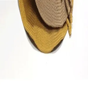 Close up detail view of foldable woven straw fisherman sun hat in yellow and khaki colors.