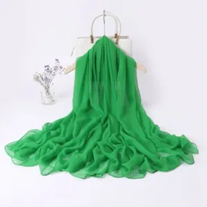 Green long scarf detail view, lightweight sheer fabric, elegant spring drapery and accessory.